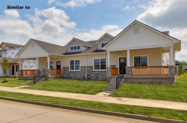 view of front facade featuring covered porch, stone siding, and a front lawn