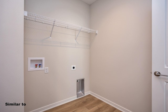 laundry area featuring hookup for a washing machine, hookup for an electric dryer, wood finished floors, laundry area, and baseboards