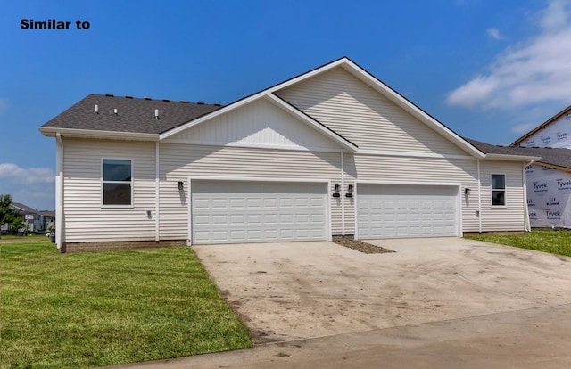 view of front of house with driveway, roof with shingles, an attached garage, and a front yard