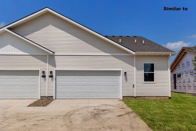 view of front of house with a front yard, driveway, and an attached garage