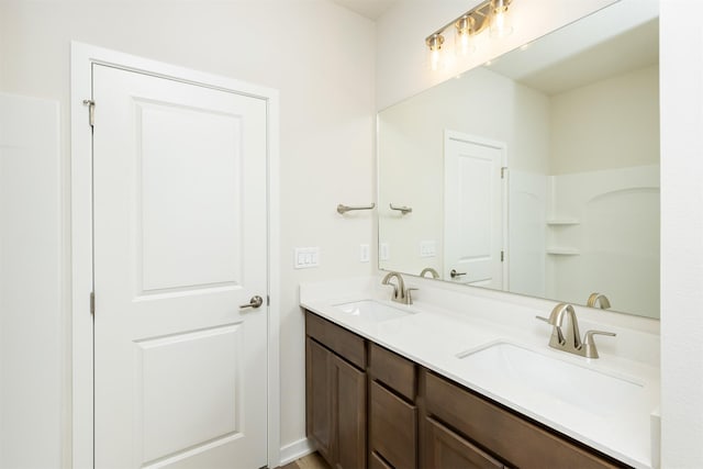 bathroom with a sink and double vanity