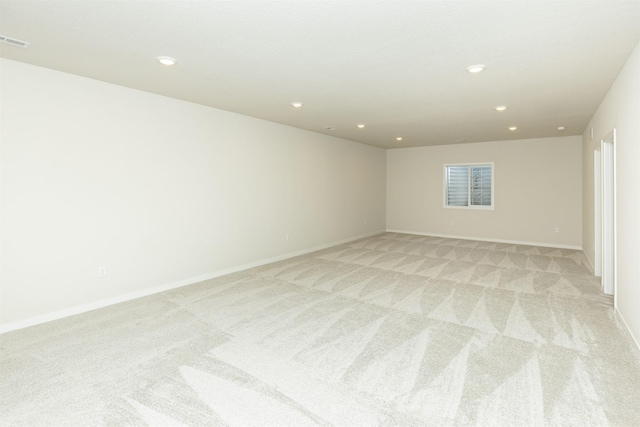 empty room featuring light carpet, visible vents, and recessed lighting