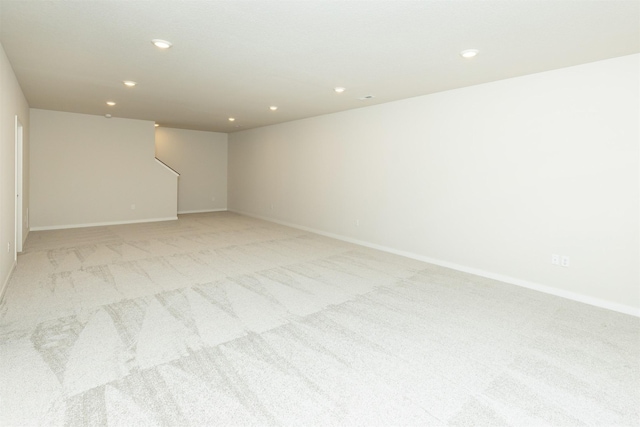 empty room with recessed lighting, baseboards, and light colored carpet