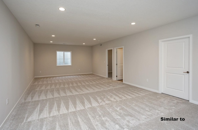 empty room with light carpet, baseboards, visible vents, a textured ceiling, and recessed lighting