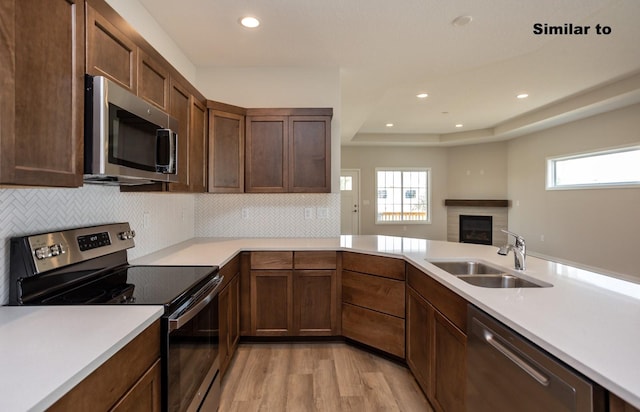 kitchen with light countertops, appliances with stainless steel finishes, and a sink