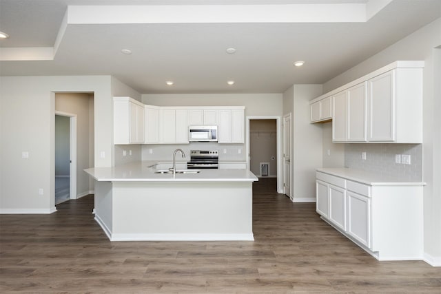 kitchen with white cabinets, tasteful backsplash, stainless steel electric range oven, and a sink
