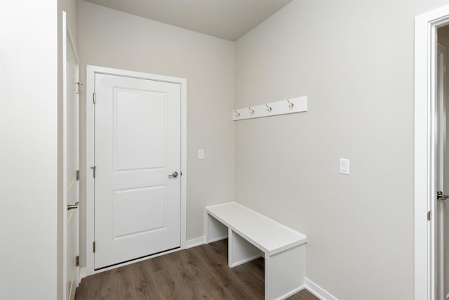 mudroom featuring dark wood-type flooring and baseboards