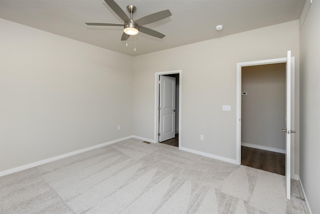 unfurnished bedroom with ceiling fan, baseboards, and carpet flooring