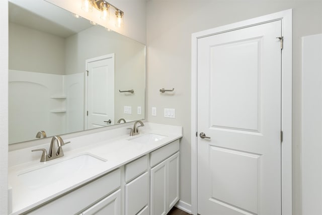 bathroom with a sink and double vanity