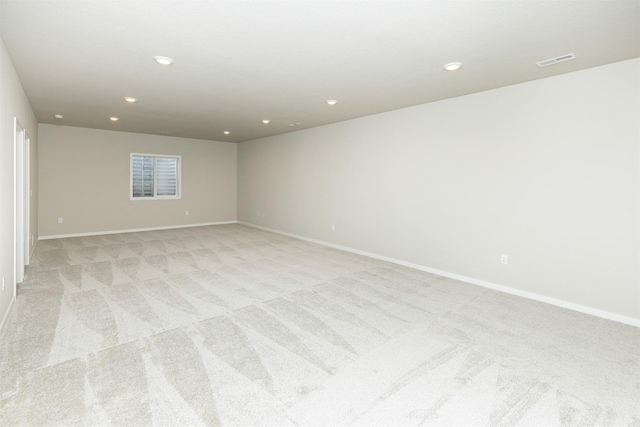 unfurnished room featuring recessed lighting, baseboards, visible vents, and light colored carpet