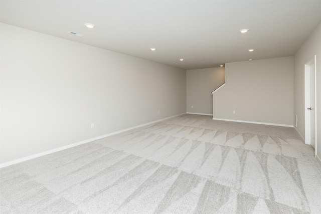 empty room with recessed lighting, baseboards, and light carpet