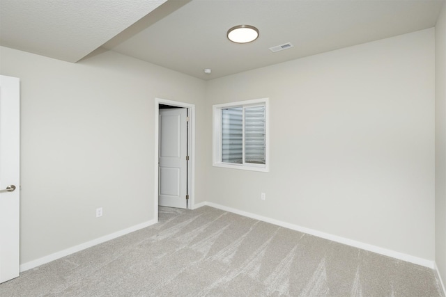 unfurnished bedroom featuring carpet floors, visible vents, and baseboards
