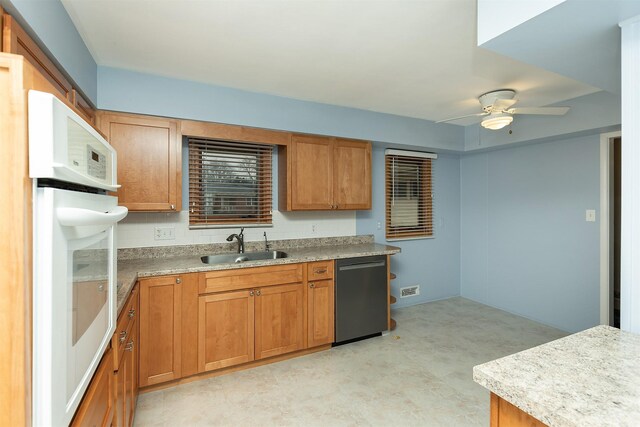 kitchen featuring ceiling fan, black dishwasher, tasteful backsplash, oven, and sink