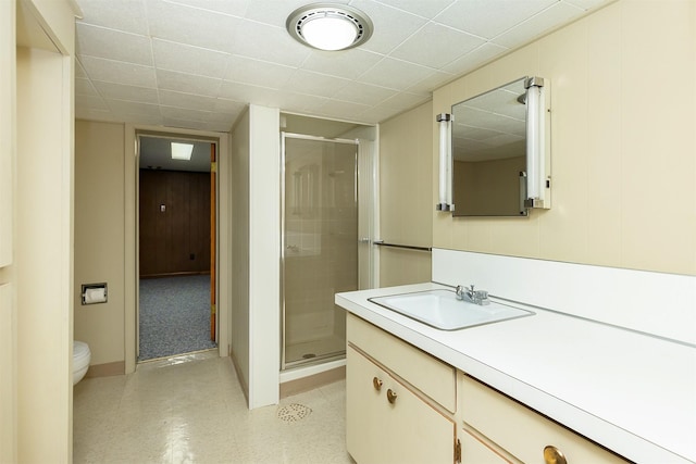 bathroom featuring an enclosed shower, vanity, and toilet