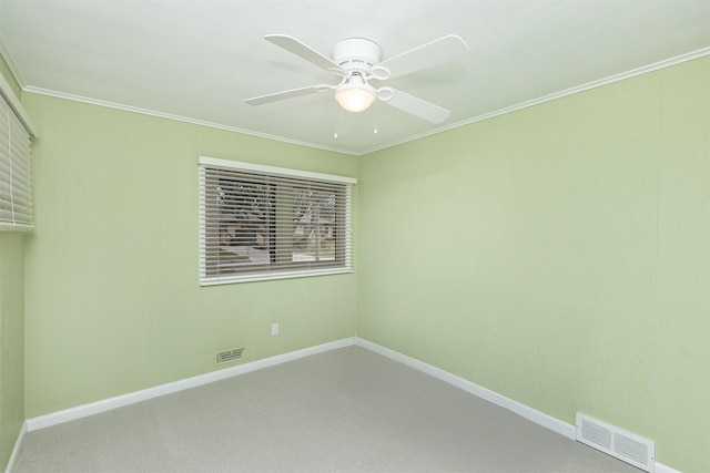 carpeted spare room featuring ceiling fan and crown molding