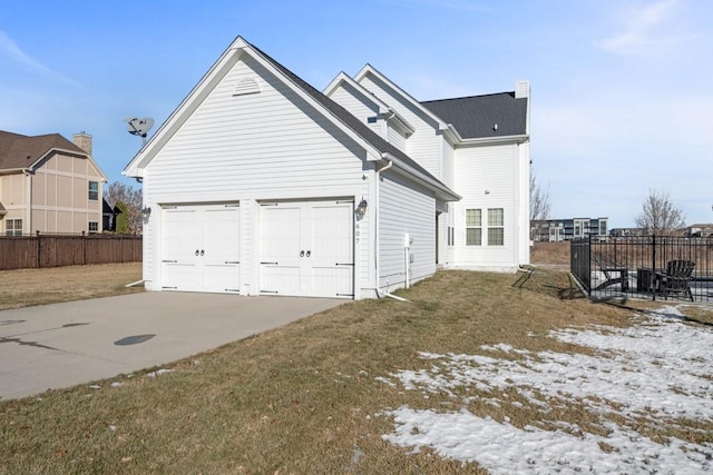 exterior space featuring a garage and a lawn