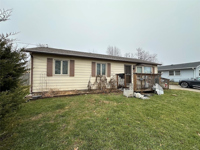 single story home featuring a front lawn and a deck