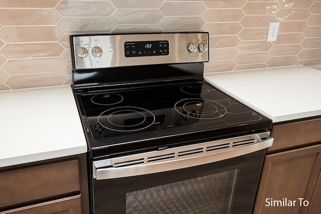 details with tasteful backsplash and stainless steel range with electric cooktop