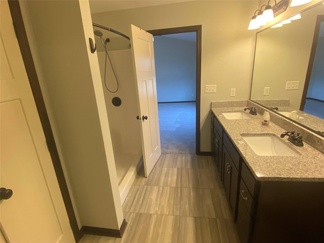 bathroom with vanity and a shower