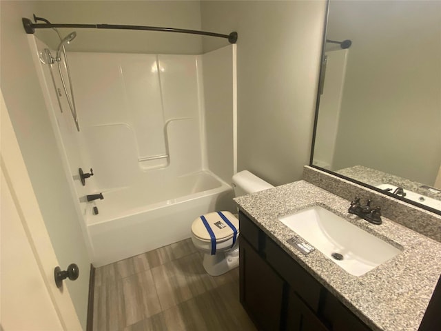 full bathroom featuring wood-type flooring, vanity, bathing tub / shower combination, and toilet