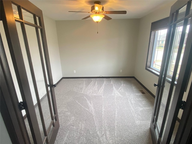 carpeted empty room with ceiling fan