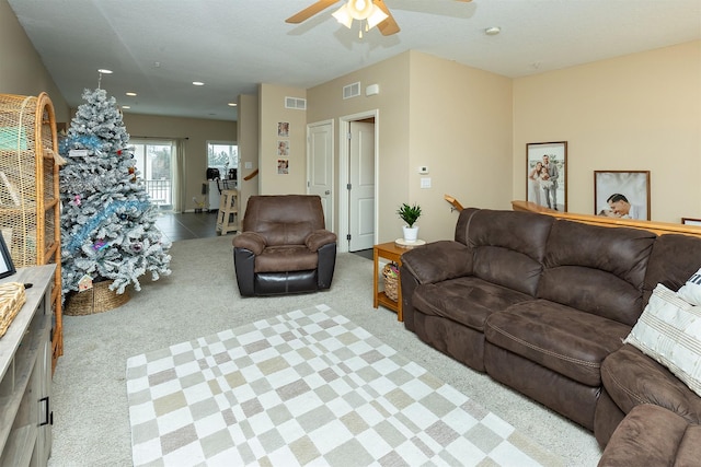 carpeted living room featuring ceiling fan