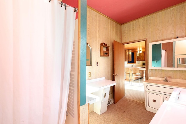 bathroom featuring wood walls, a shower with curtain, and vanity