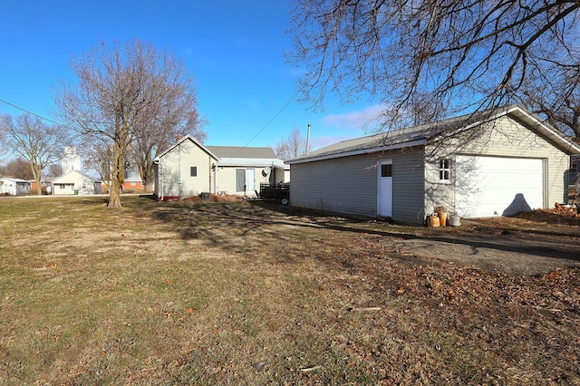 exterior space with an outdoor structure and a front yard