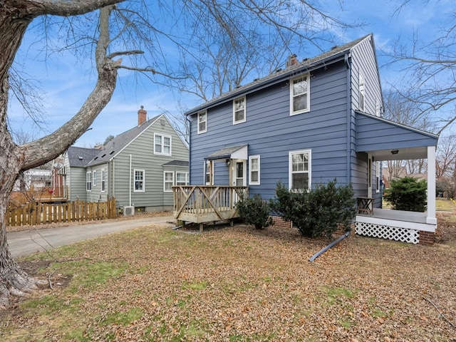 rear view of property with a wooden deck