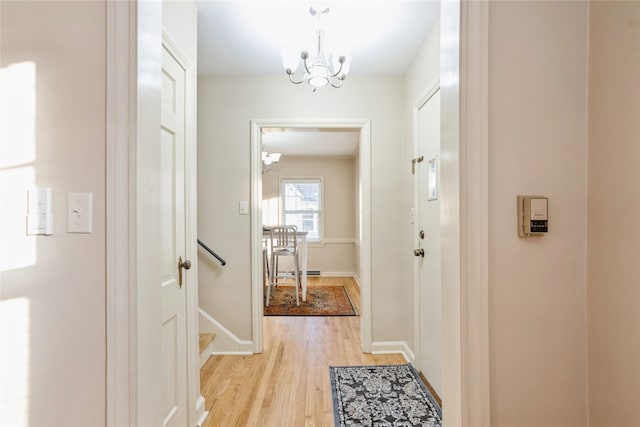 interior space featuring light hardwood / wood-style floors and a chandelier