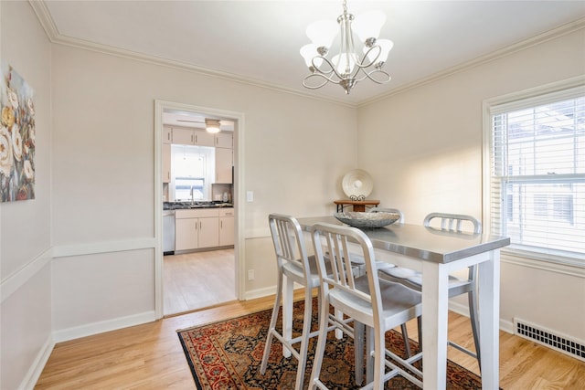 dining area featuring light hardwood / wood-style flooring, a chandelier, and plenty of natural light