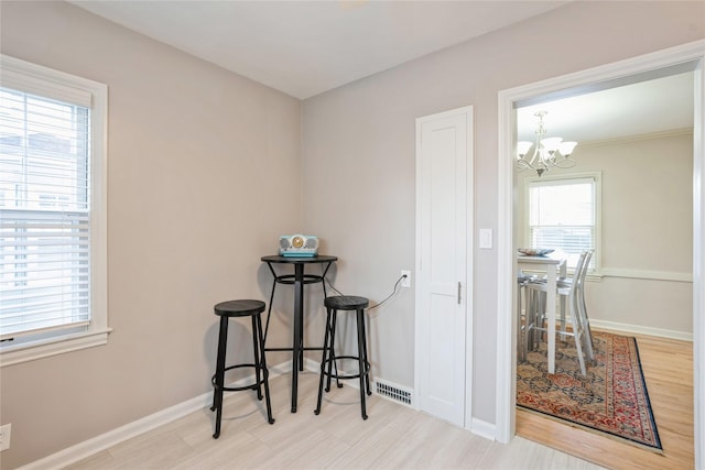 dining area featuring light hardwood / wood-style floors and a notable chandelier