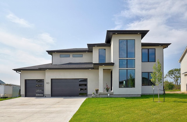 view of front facade with a garage and a front lawn