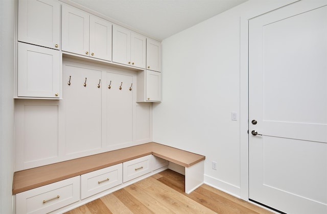 mudroom featuring light wood-style floors and baseboards