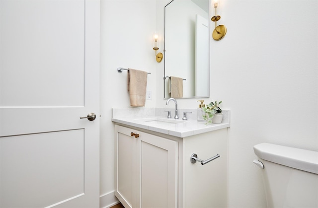 half bath featuring toilet and vanity