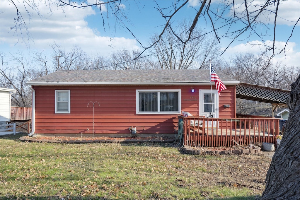 back of house with a yard and a deck