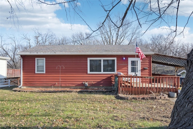 back of house with a yard and a deck