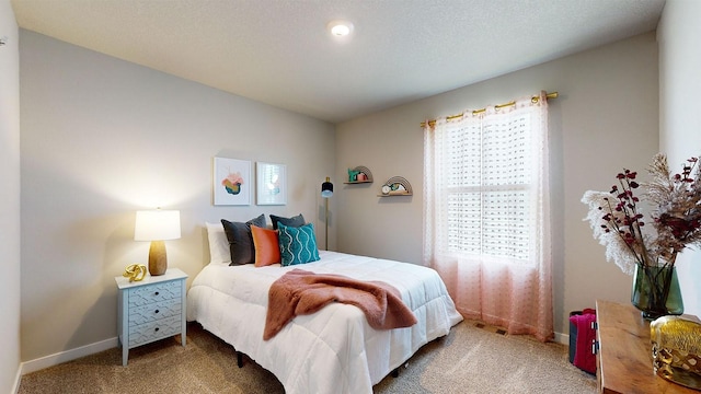 carpeted bedroom featuring a textured ceiling