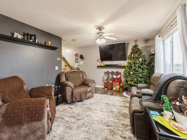 living room with ceiling fan and hardwood / wood-style floors