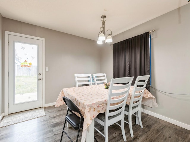 dining room featuring a notable chandelier and hardwood / wood-style flooring