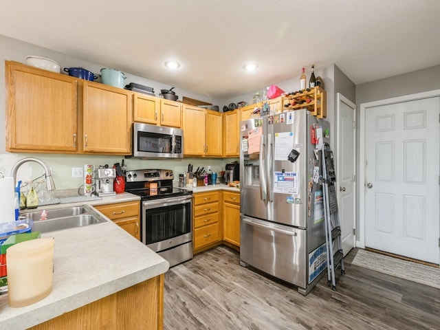 kitchen featuring light brown cabinetry, hardwood / wood-style flooring, sink, and appliances with stainless steel finishes