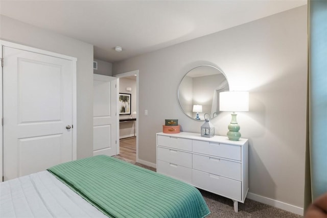 bedroom with dark colored carpet