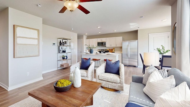 1155 Magnolia Ln, Waukee, IA 50263 - living room featuring light wood-type flooring, a ceiling fan, and recessed lighting