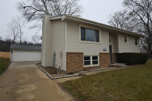 split foyer home featuring a garage, an outbuilding, and a front yard