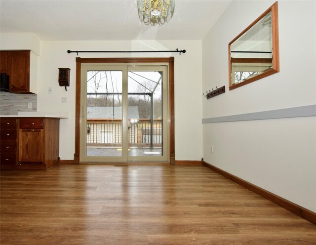 interior space featuring a chandelier and light wood-type flooring