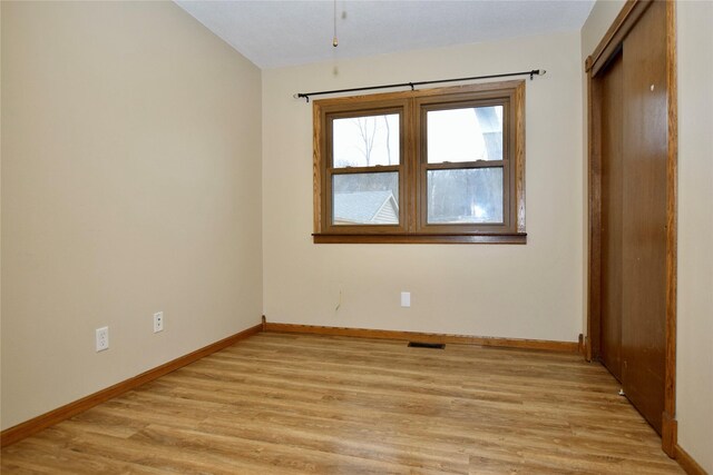 unfurnished room with light wood-type flooring