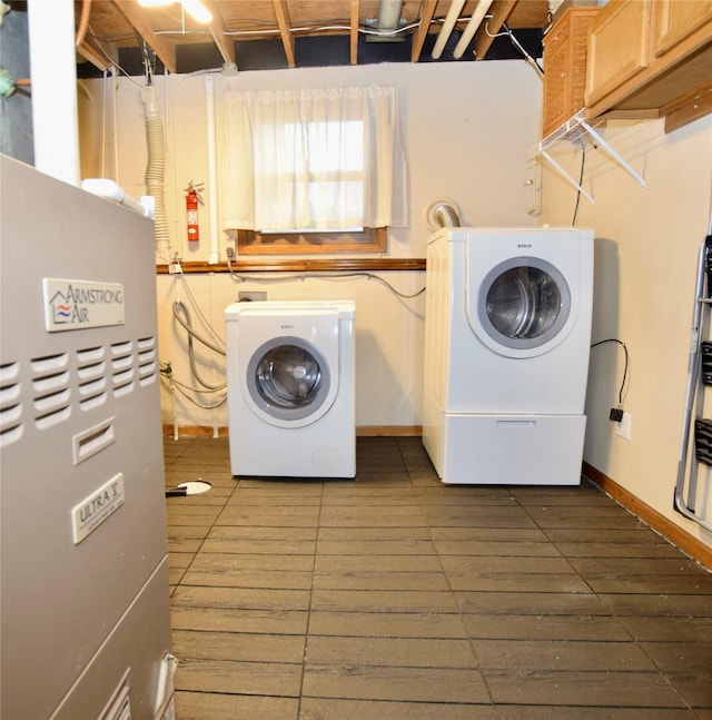 laundry area with washer and dryer and heating unit