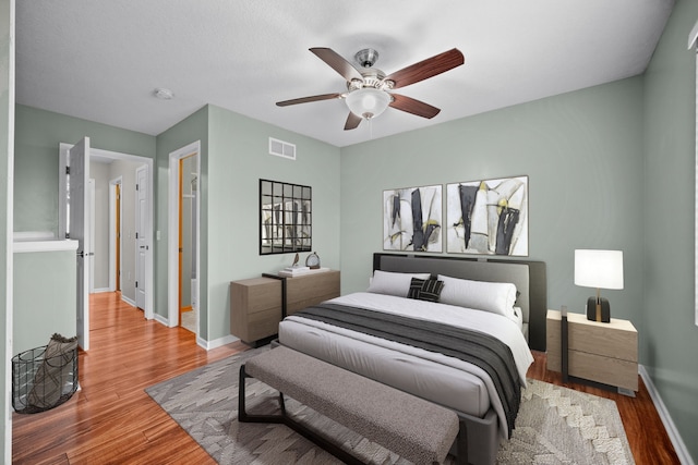 bedroom with wood-type flooring and ceiling fan