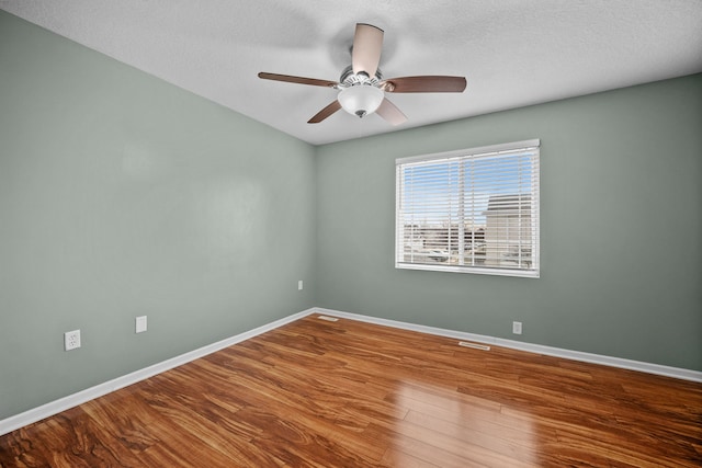 unfurnished room with hardwood / wood-style flooring, a textured ceiling, and ceiling fan