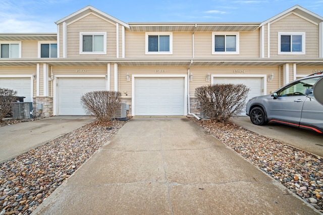 view of property featuring cooling unit and a garage